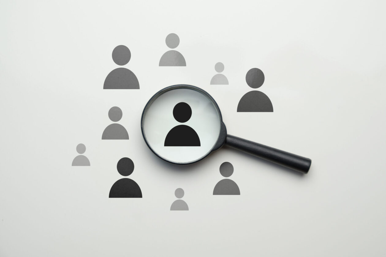 Employee search HR concept – magnifier with abstract employee on a white background.